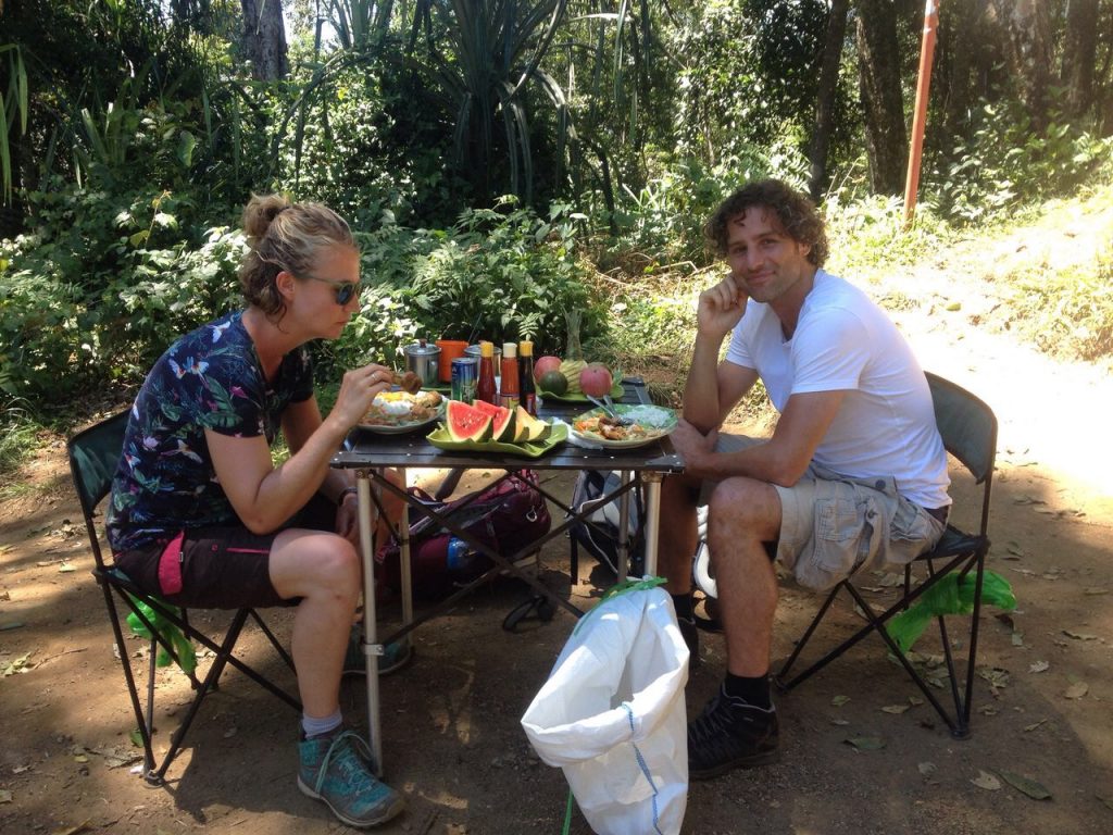 two people sat at a table eating a meal whilst on their rinjani hike