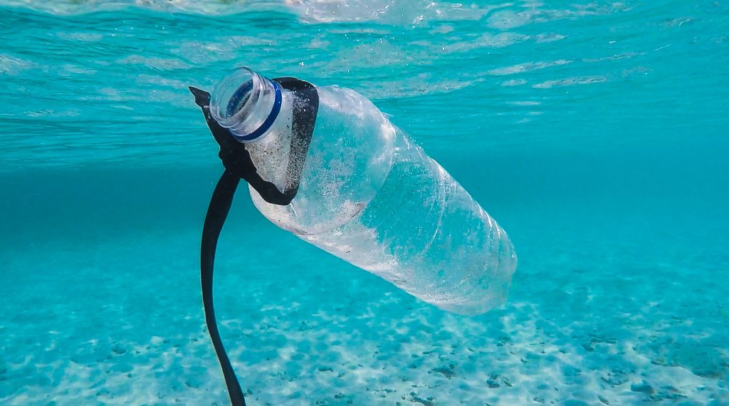 bottle floating in water pollution 